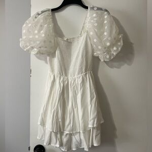 White romper with puff sleeves.